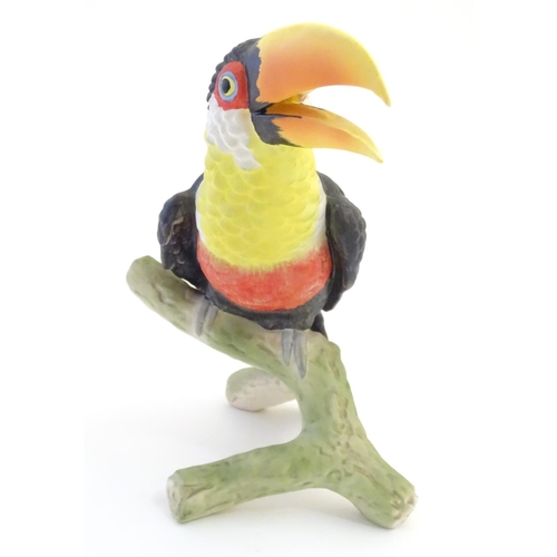 81 - A W. Goebel model of a green billed toucan bird perched on a branch. Signature and model number impr... 