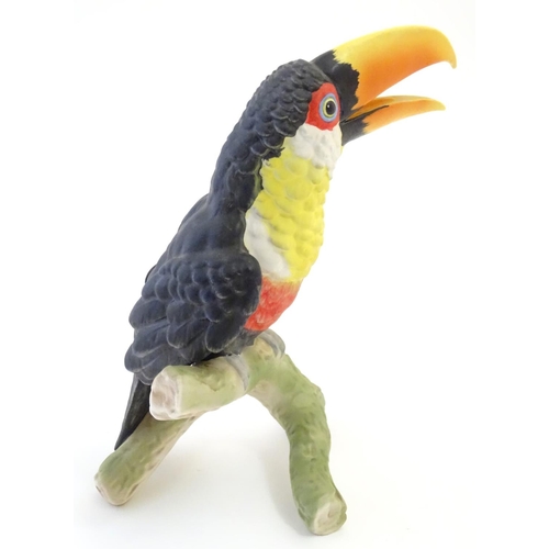 81 - A W. Goebel model of a green billed toucan bird perched on a branch. Signature and model number impr... 