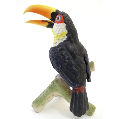81 - A W. Goebel model of a green billed toucan bird perched on a branch. Signature and model number impr... 