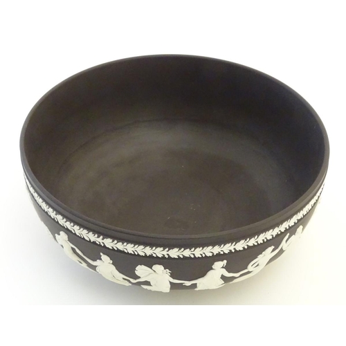 85 - A black Wedgwood Jasperware bowl decorated with classical figures, the Dancing Hours, with a border ... 