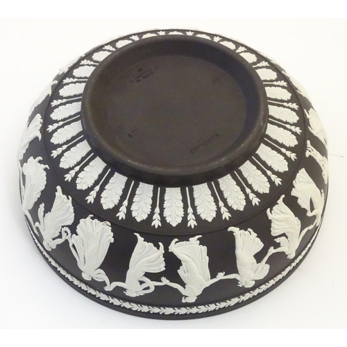 85 - A black Wedgwood Jasperware bowl decorated with classical figures, the Dancing Hours, with a border ... 
