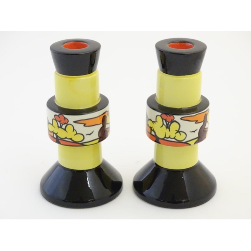92 - A pair of candlesticks by Lorna Bailey in the pattern Dinsdale Hall. Signed under. Approx. 6 ¾'' hig... 