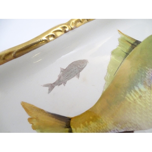 93 - A Villeroy and Boch elongated oblong serving dish with fish decoration and a gilt rim. Marked under.... 