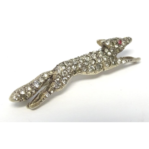 213 - A white metal brooch forme as a running fox with a profusion of white stones 1 3/4'' long