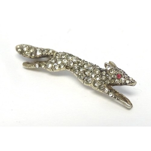 213 - A white metal brooch forme as a running fox with a profusion of white stones 1 3/4'' long