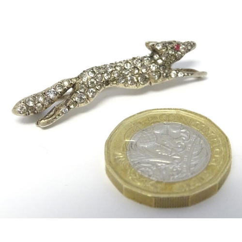 213 - A white metal brooch forme as a running fox with a profusion of white stones 1 3/4'' long