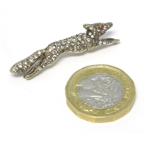 213 - A white metal brooch forme as a running fox with a profusion of white stones 1 3/4'' long