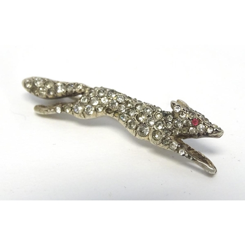213 - A white metal brooch forme as a running fox with a profusion of white stones 1 3/4'' long