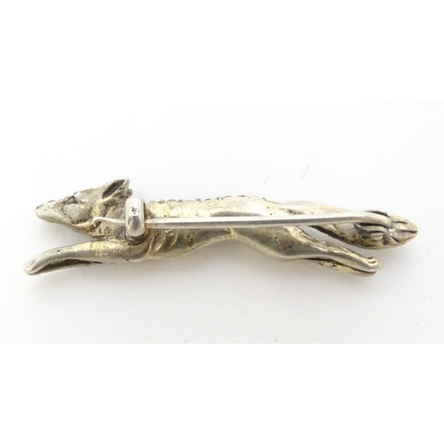 213 - A white metal brooch forme as a running fox with a profusion of white stones 1 3/4'' long
