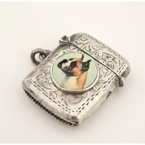 216 - A silver vesta case with later applied 21stC ceramic cabochon with dog decoration. The whole 1 3/4''... 