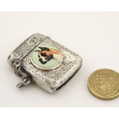 216 - A silver vesta case with later applied 21stC ceramic cabochon with dog decoration. The whole 1 3/4''... 