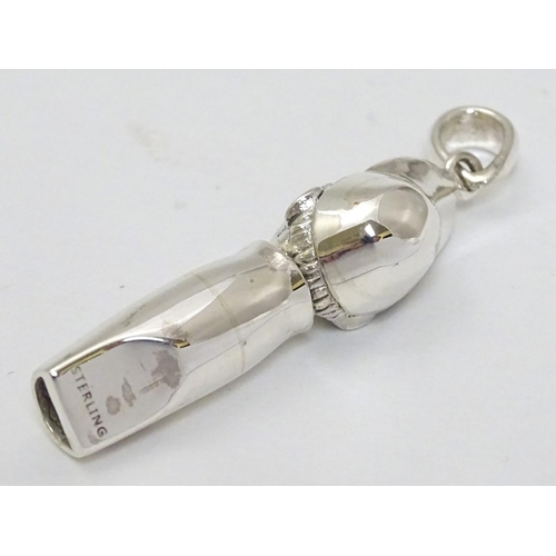241 - Horse Racing Interest: A novelty whistle formed as the head of a jockey with red stone eyes.  Marked... 