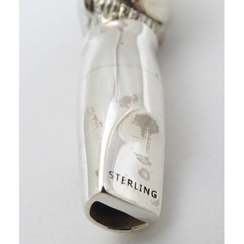 241 - Horse Racing Interest: A novelty whistle formed as the head of a jockey with red stone eyes.  Marked... 