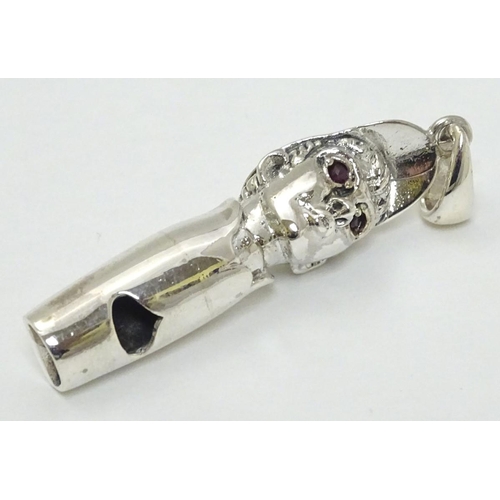 241 - Horse Racing Interest: A novelty whistle formed as the head of a jockey with red stone eyes.  Marked... 