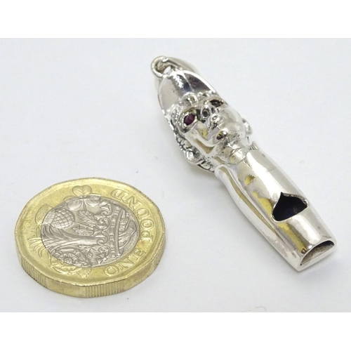 241 - Horse Racing Interest: A novelty whistle formed as the head of a jockey with red stone eyes.  Marked... 