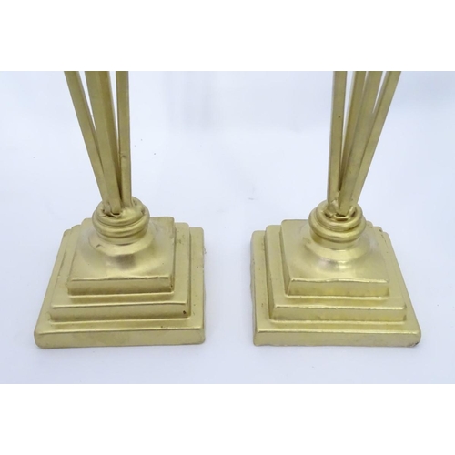 203 - A pair of tall gilt candle sticks with glass drops