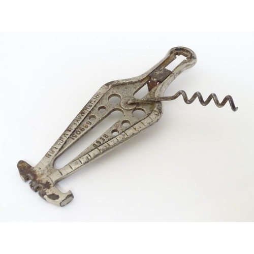 222 - A 1922 combination corkscrew with can opener, 3 inch ruler, glass cutter, a gauge and crown cork ope... 