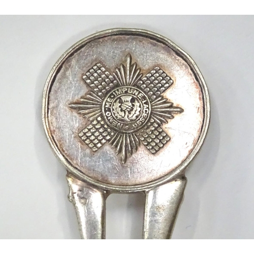 239 - A white metal spoon, the stem formed as two rifles with guards emblem