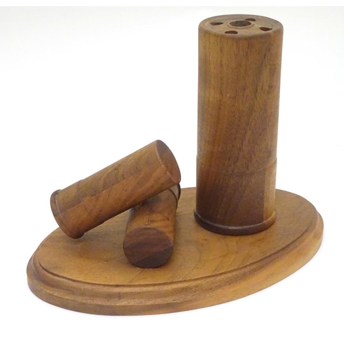 253 - Shooting: a walnut desk tidy, formed as three shotgun cartridges. 7'' tall, 9 1/2'' wide, 6'' deep