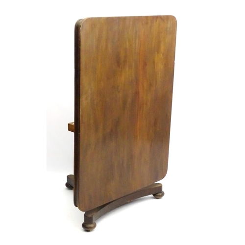 293 - A mid 19thC mahogany tilt top breakfast table, with large rectangular top above a turned column and ... 