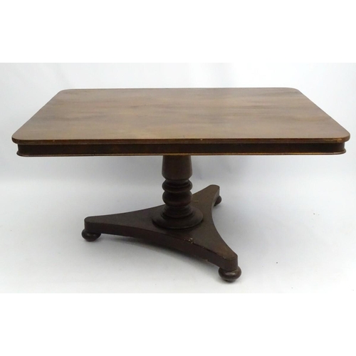 293 - A mid 19thC mahogany tilt top breakfast table, with large rectangular top above a turned column and ... 