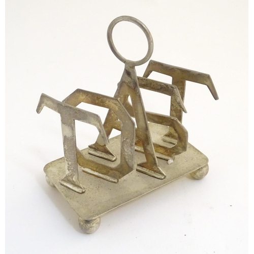 357 - A 21stC silver plated toast rack, the divisions formed as the letters 'TOAST'. 4 1/4'' long, 5'' tal... 