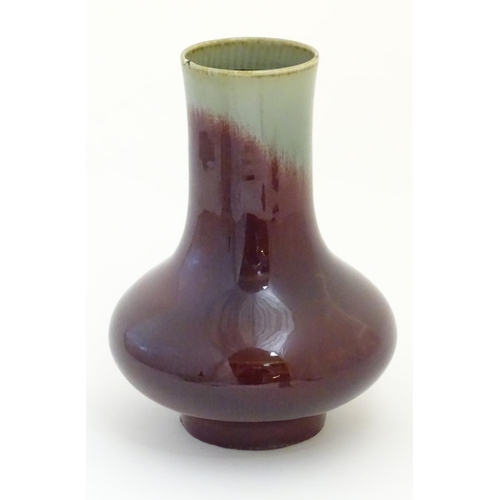 11 - A Chinese sang de boeuf two tone vase with a crackle glaze. Character marks under. 11 1/2'' high.