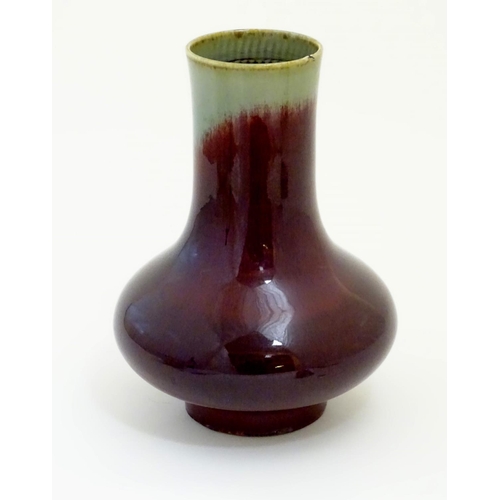 11 - A Chinese sang de boeuf two tone vase with a crackle glaze. Character marks under. 11 1/2'' high.
