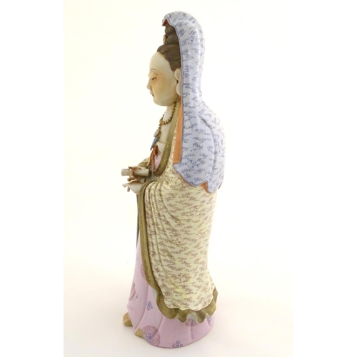12 - A Chinese famille rose standing figure of Guanyin, the Buddhist bodhisattva associated with compassi... 