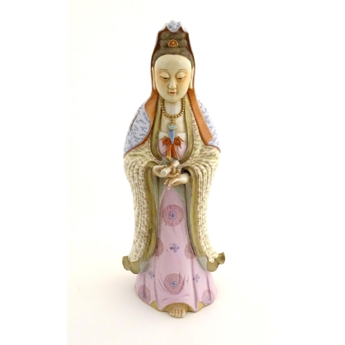 12 - A Chinese famille rose standing figure of Guanyin, the Buddhist bodhisattva associated with compassi... 