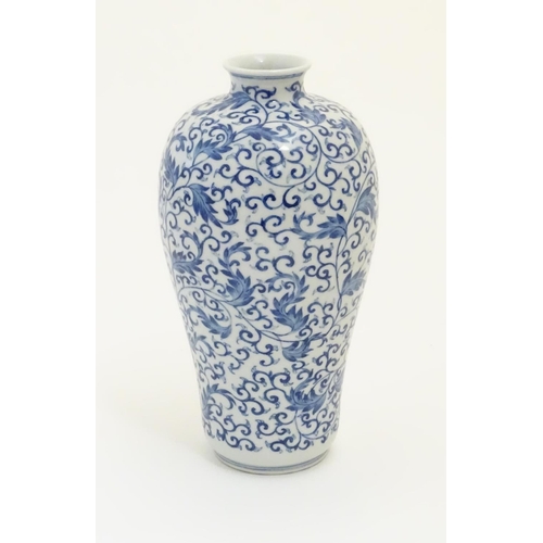 13 - A Chinese blue and white 'Plum' vase decorated with scrolling foliage. Character marks under. Approx... 