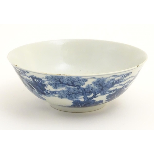16 - A Chinese blue and white bowl depicting figures in a landscape. Character marks under. Approx 2 3/4'... 