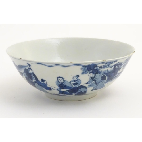16 - A Chinese blue and white bowl depicting figures in a landscape. Character marks under. Approx 2 3/4'... 