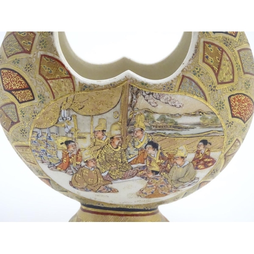 19 - A Japanese satsuma moon basket vase with hand painted decoration depicting figures seated around imp... 