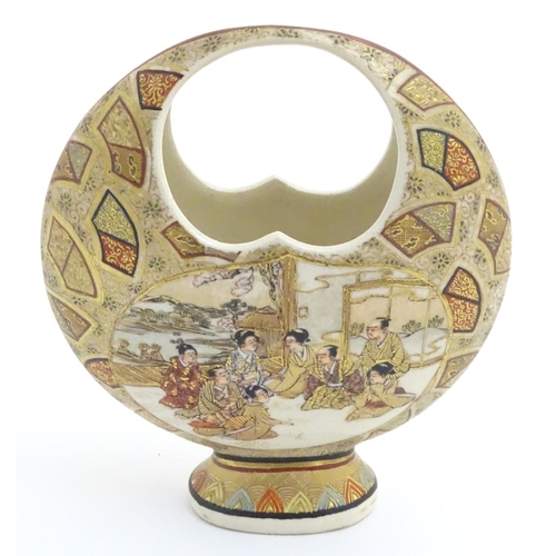 19 - A Japanese satsuma moon basket vase with hand painted decoration depicting figures seated around imp... 