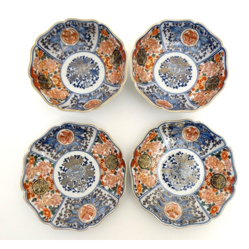 15 - A pair of Japanese Imari plates and matching pair of bowls, having decorative floral and foliate pan... 