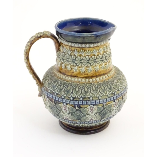 30 - A 19thC Doulton Lambeth jug with a banded floral design in relief by Clara Baker. Doulton Lambeth st... 