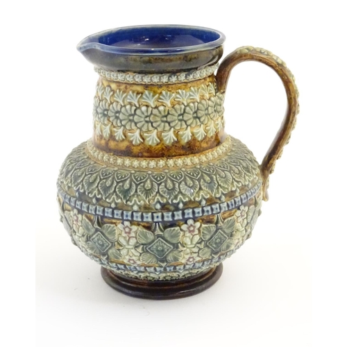 30 - A 19thC Doulton Lambeth jug with a banded floral design in relief by Clara Baker. Doulton Lambeth st... 