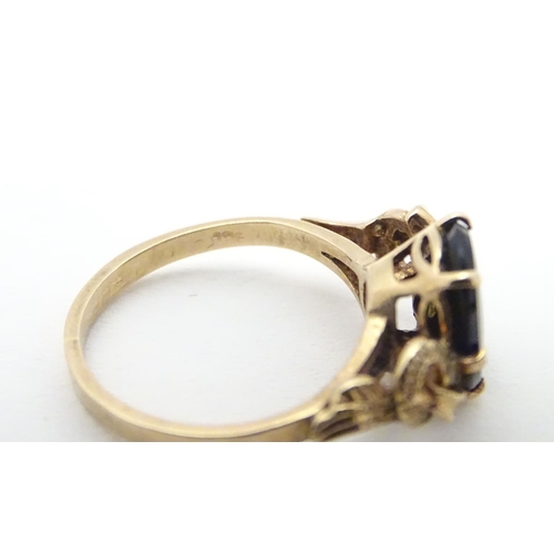 411 - A 9ct gold ring set with black onyx cabochon. Ring size approx H.