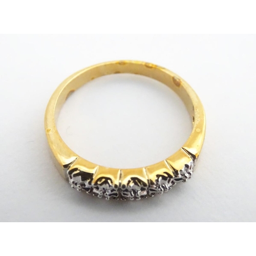 412A - A gilt metal ring set with 5 chip set diamonds. Ring size approx. Q