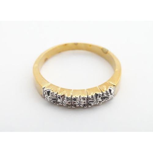 412A - A gilt metal ring set with 5 chip set diamonds. Ring size approx. Q