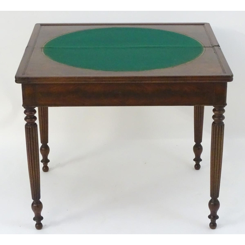 1102 - A late Georgian mahogany folding card table, having a moulded rectangular top above four reeded tape... 