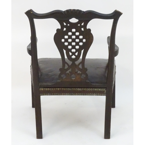 1103 - An Irish 19thC mahogany Chinese Chippendale open armchair with carved frame and pierced back splat, ... 