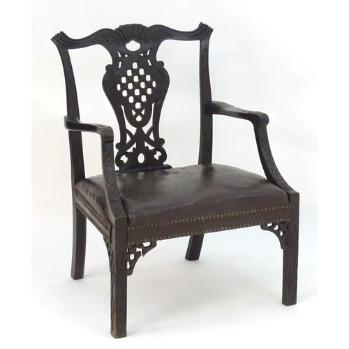 1103 - An Irish 19thC mahogany Chinese Chippendale open armchair with carved frame and pierced back splat, ... 