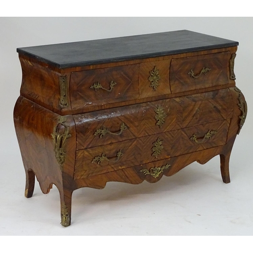 1104 - A late 20thC kingwood bombe commode with an ebonised top above three long drawers with ormolu handle... 