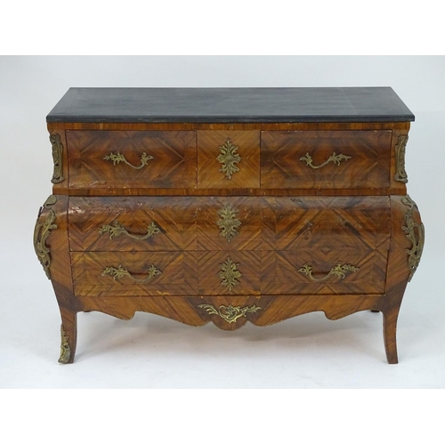 1104 - A late 20thC kingwood bombe commode with an ebonised top above three long drawers with ormolu handle... 