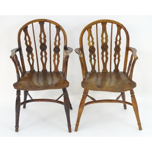 1020 - Two early / mid 19thC yew wood draught back Windsor chairs, with bowed backs and three carved back s... 
