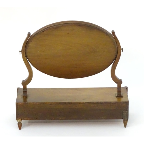 1022 - An early 19thC mahogany dressing table mirror, with an oval frame above three short drawers and rais... 
