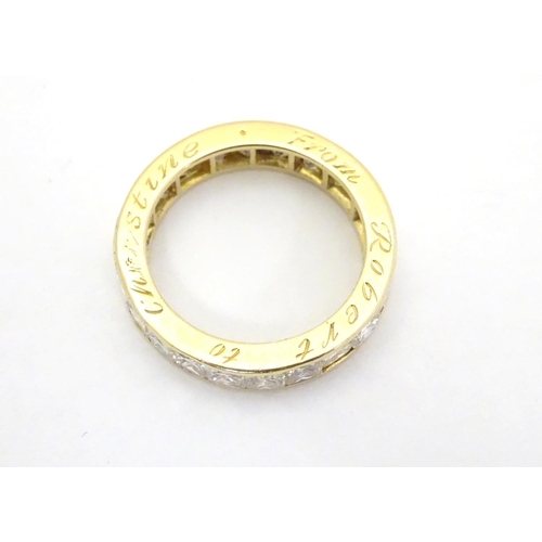 412 - An 18ct gold eternity ring set with 22 Princess cut diamonds. Each diamond approx 3.5mm wide. Ring s... 