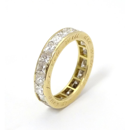 412 - An 18ct gold eternity ring set with 22 Princess cut diamonds. Each diamond approx 3.5mm wide. Ring s... 